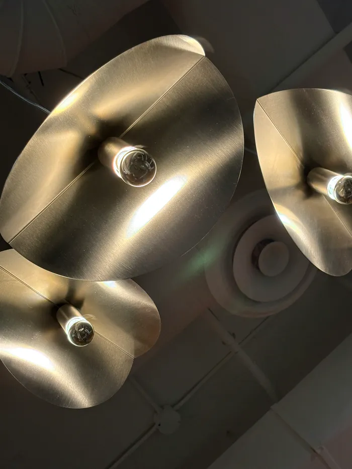 Polished metal bowls hanging as light fittings