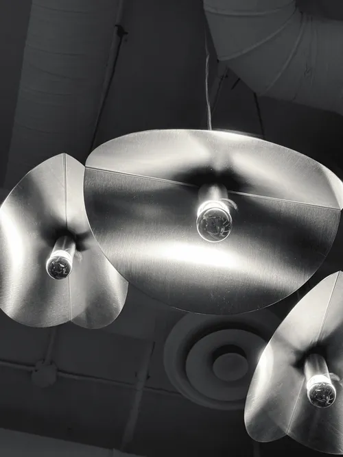 Polished metal bowls hanging as light fittings