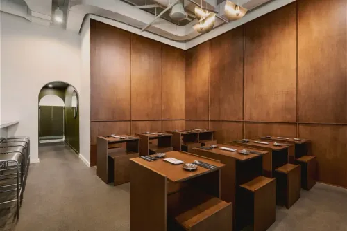 Rows of wooden tables in the wood-panelled Nui dining room